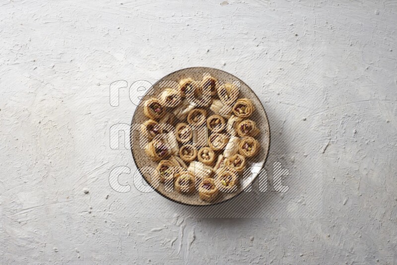 Oriental sweets in pottery plates in a light setup