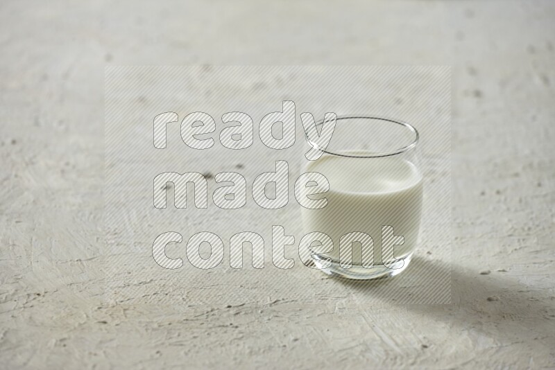 Cold drinks in a glass cup such as water, tamarind, qamar eldin, sobia, milk and hibiscus on textured white background