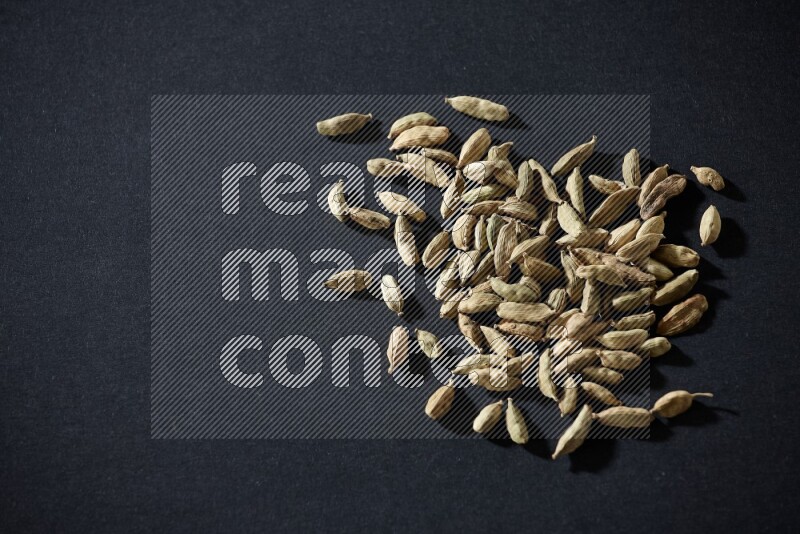 Cardamom seeds on black flooring