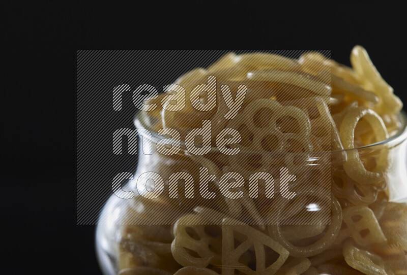 Snacks in a glass jar on black background