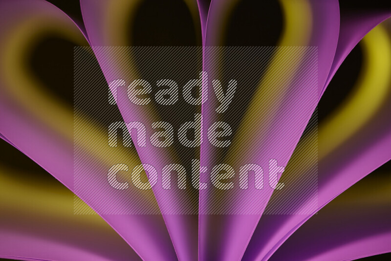 An abstract art piece displaying smooth curves in yellow and pink gradients created by colored light