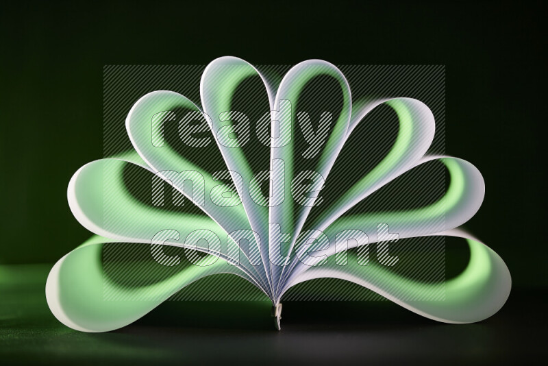 An abstract art piece displaying smooth curves in green and white gradients created by colored light