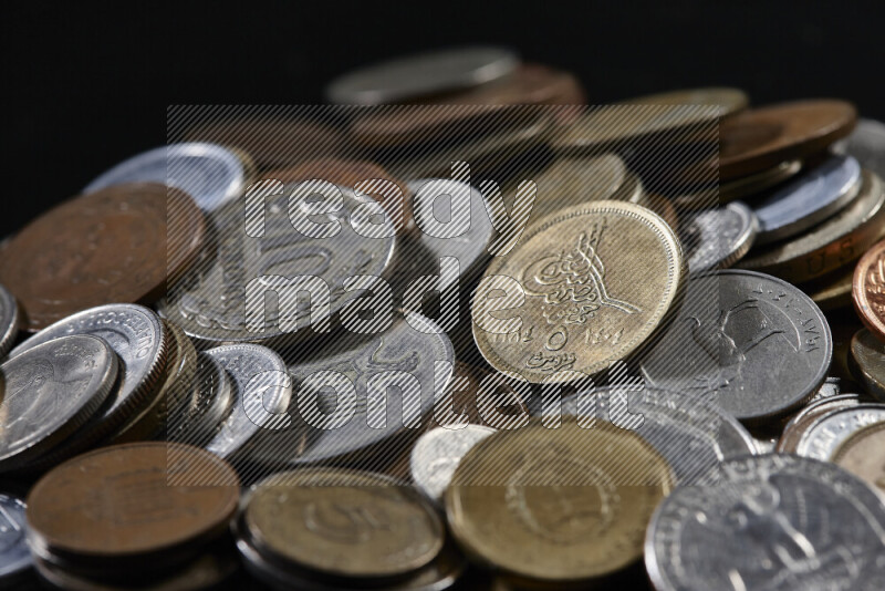 A close-ups of random old coins on black background