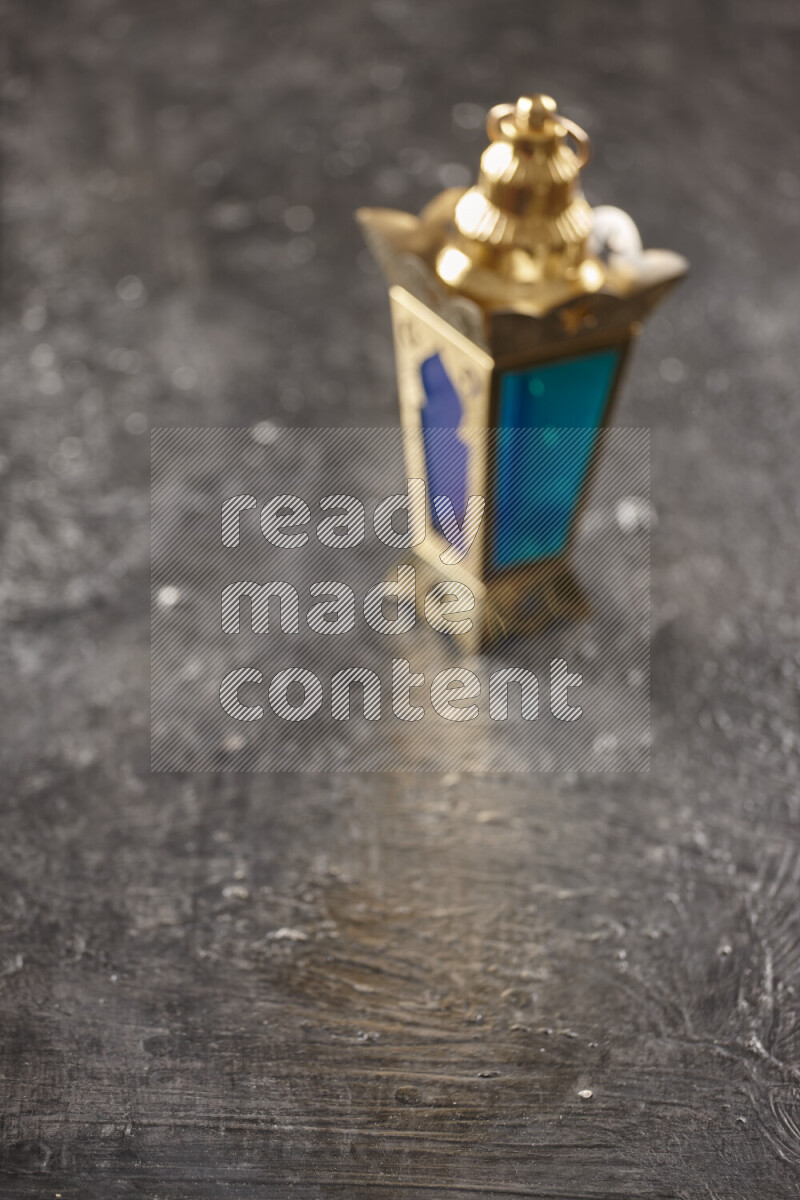 A lantern placed on a textured black background