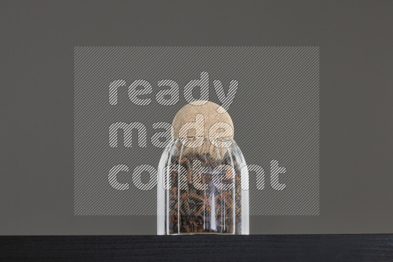 Star anise in a glass jar on black background