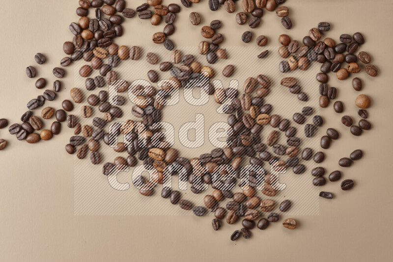 Roasted coffee beans on beige background