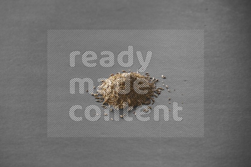 Cumin on a black flooring