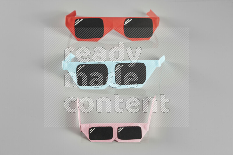 Origami sun glasses on grey background