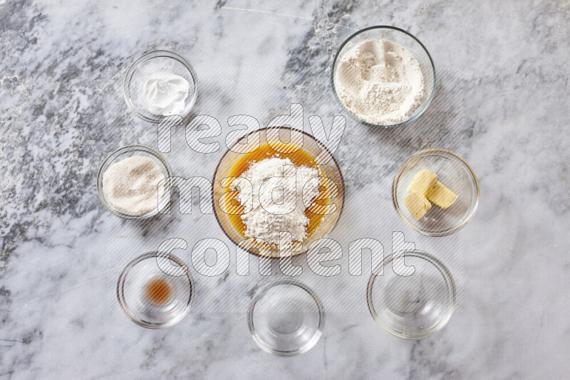 Cookies step by step with its ingredient, flour, butter, brown sugar, egg, vanilla extract, white sugar, chocolate chips and baking soda on grey marble background