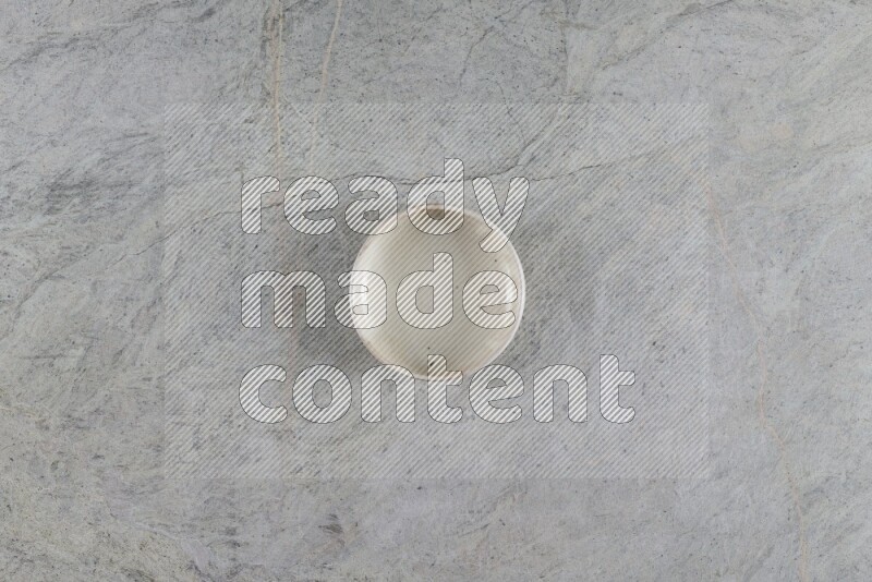 A white pottery bowl on grey marble background