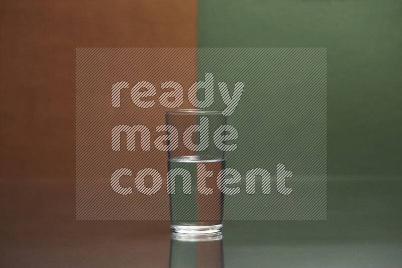 The image features a clear glassware filled with water, set against brown and dark green background
