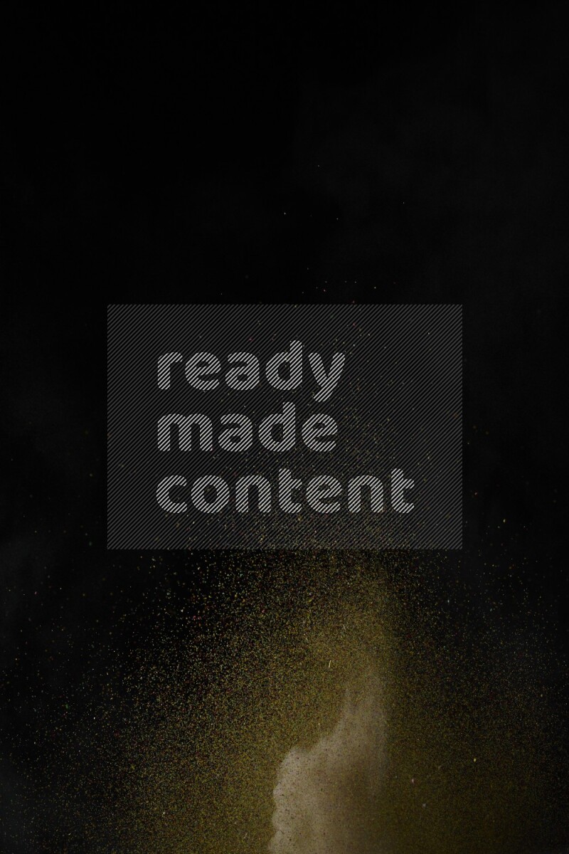 A side view of brown powder explosion on black background