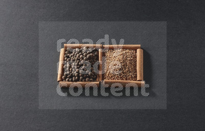 2 squares of cinnamon sticks full of mustard seeds and allspice on black flooring