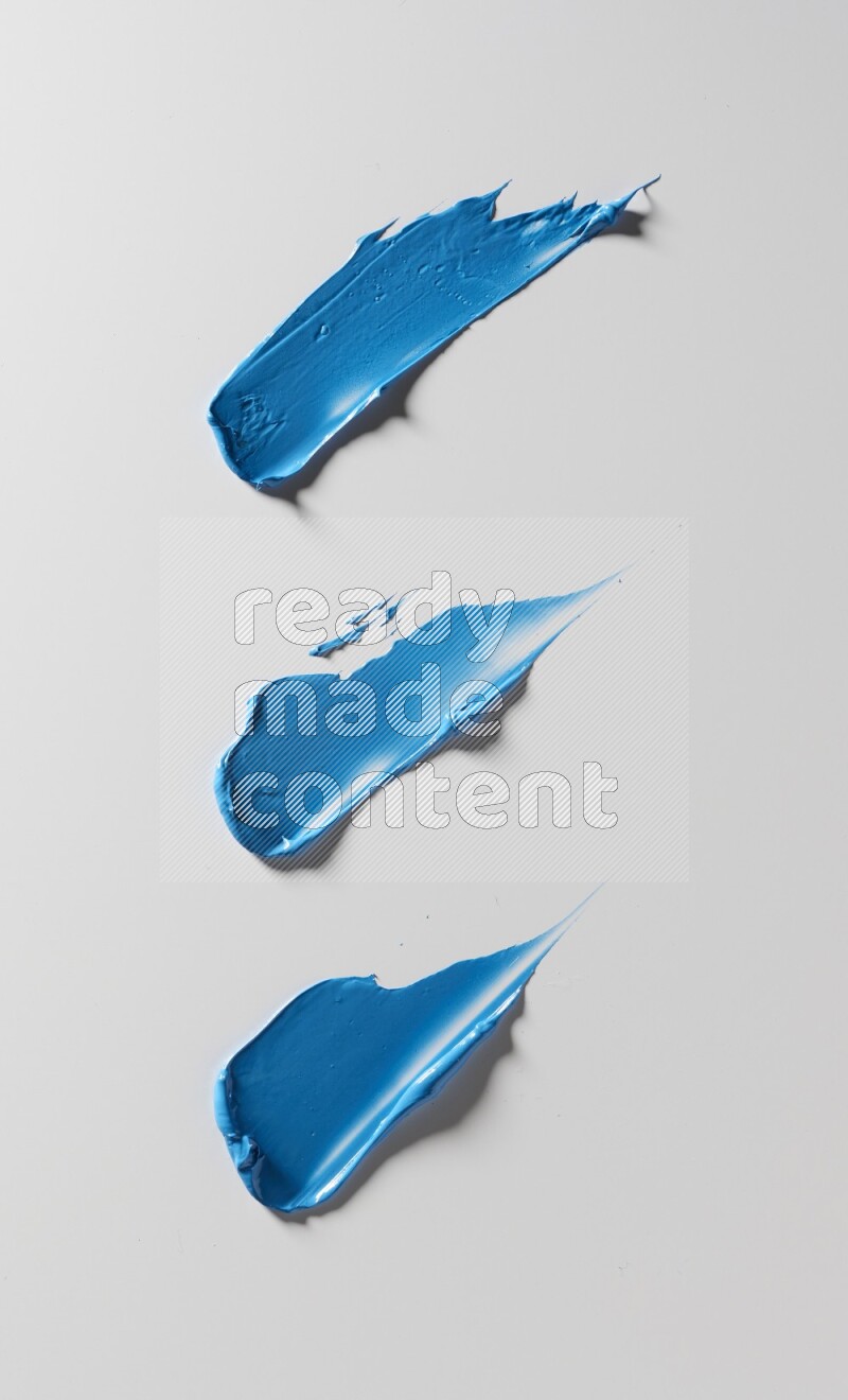 Blue painting knife strokes on white background