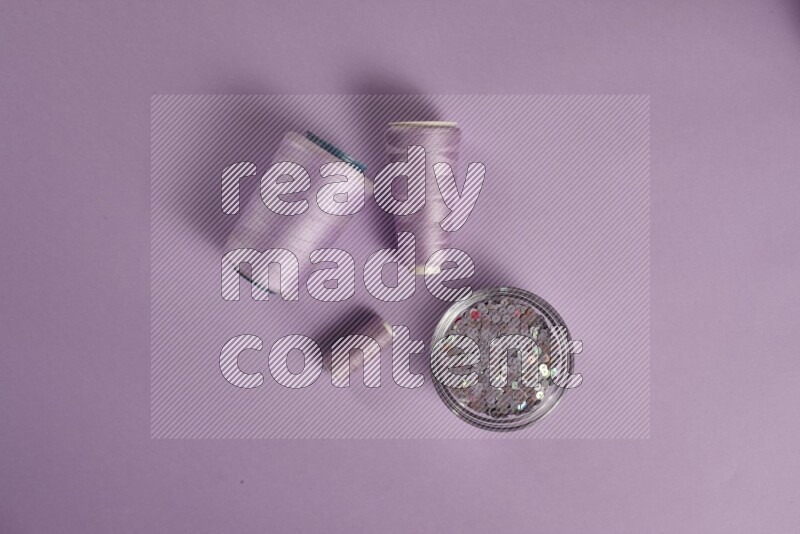 A purple collection of sewing and tailoring tools arranged on a purple background