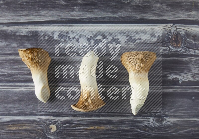 Fresh King oysters mushrooms topview on a grey wooden background