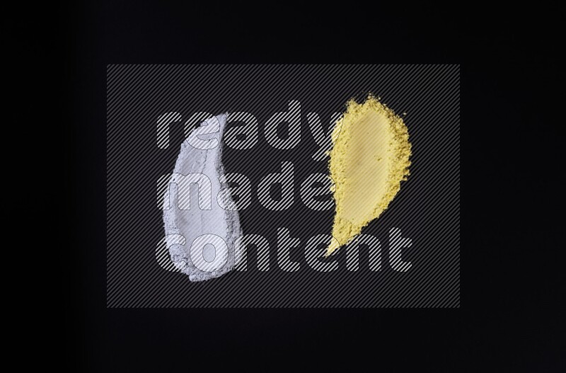 Multicolored powder smears on black background