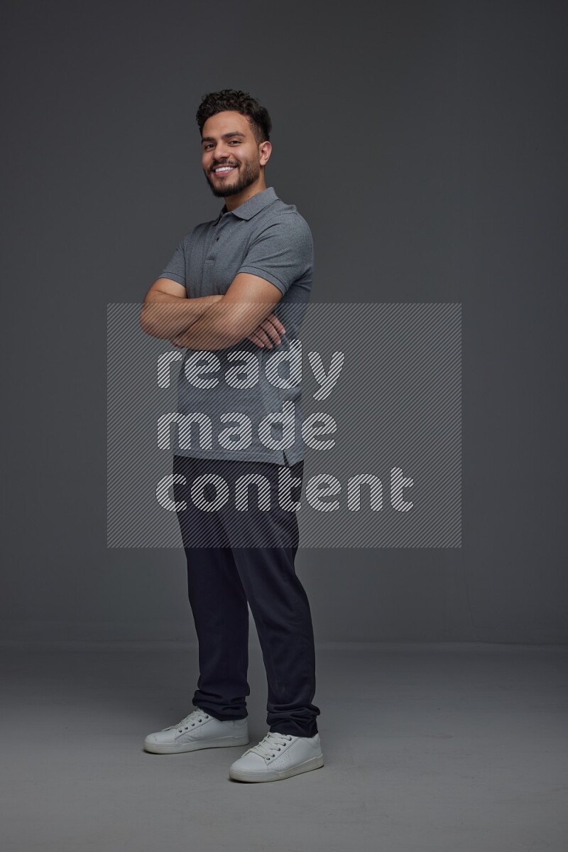 A man wearing casual making multi stand poses  eye level on a gray background