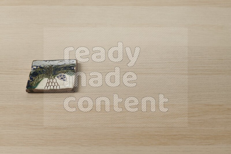 A decorative coaster on light wooden background