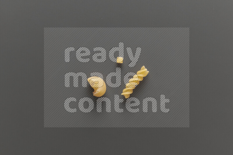 Different pasta types on grey background