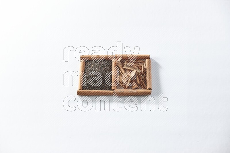 2 squares of cinnamon sticks full of black tea and cinnamon on white flooring