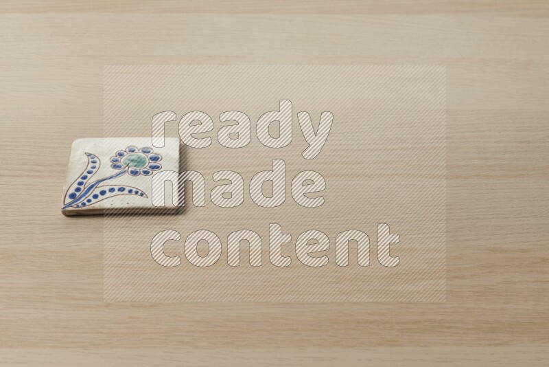 A decorative coaster on light wooden background