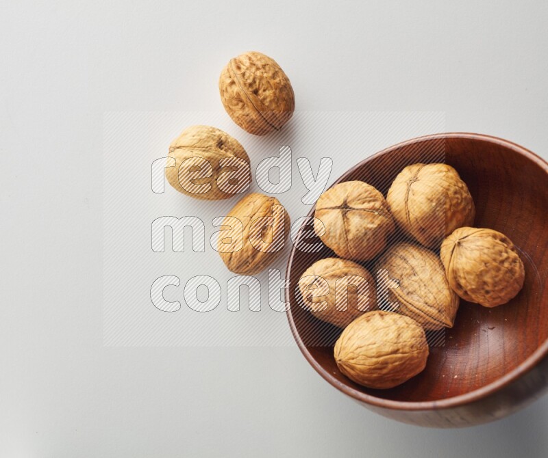 Top-view shot of walnut in a container on white background