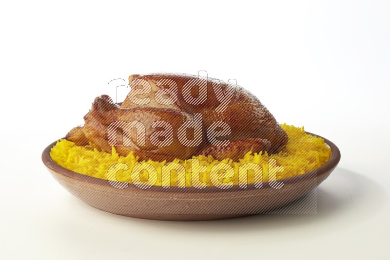 yellow basmati Rice with whole roasted chicken  on a pottery plate  direct  on white background