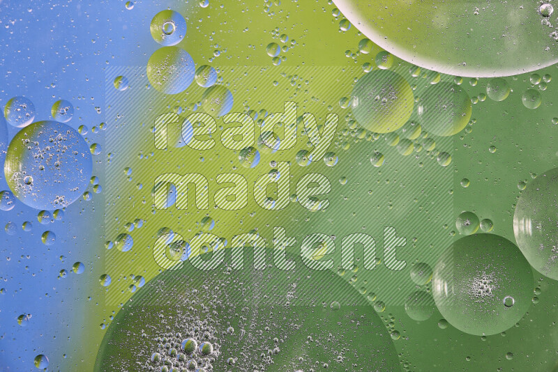 Close-ups of abstract oil bubbles on water surface in shades of green and blue