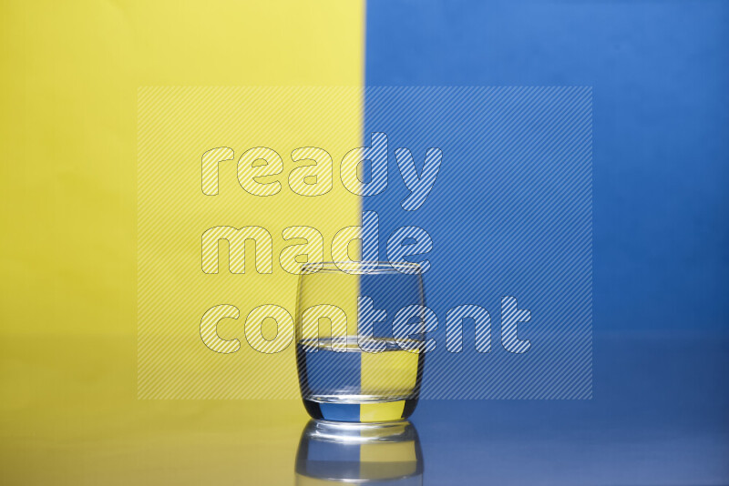 The image features a clear glassware filled with water, set against yellow and blue background