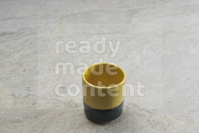 A multicolored pottery Cup on grey marble background