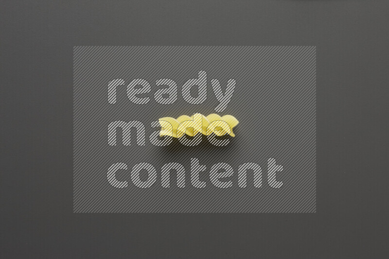 Fusilli pasta on grey background
