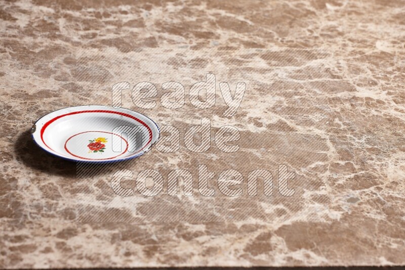 A vintage metal plate on beige marble background