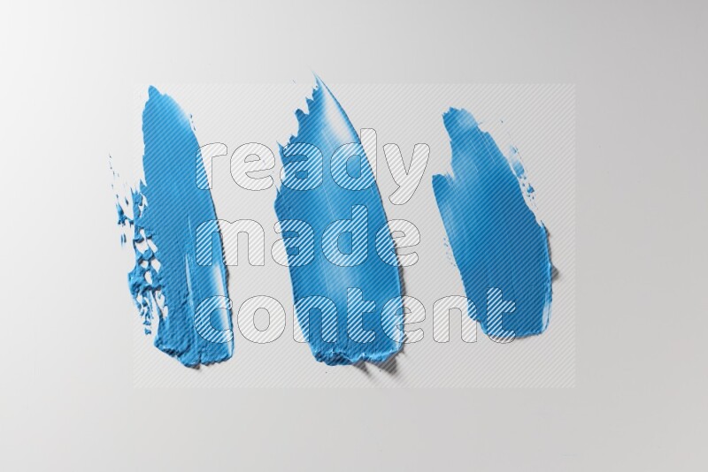 Blue painting knife strokes on a white background