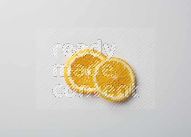 Two orange slices on white background