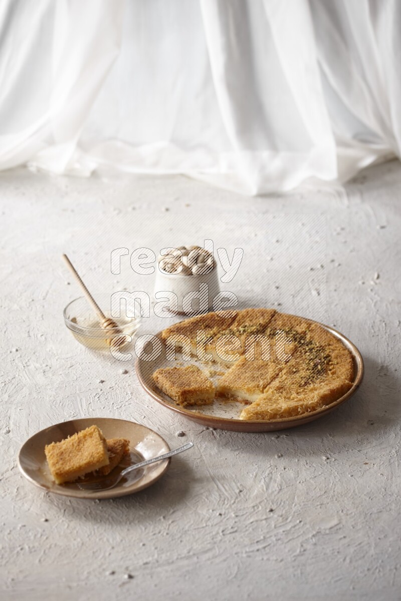 Konafa with nuts and honey in a light setup
