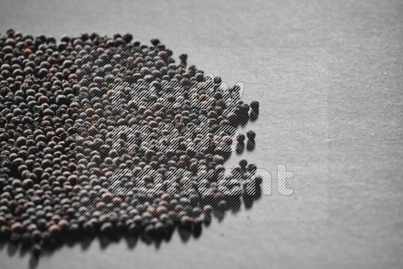 Black pepper on a black flooring
