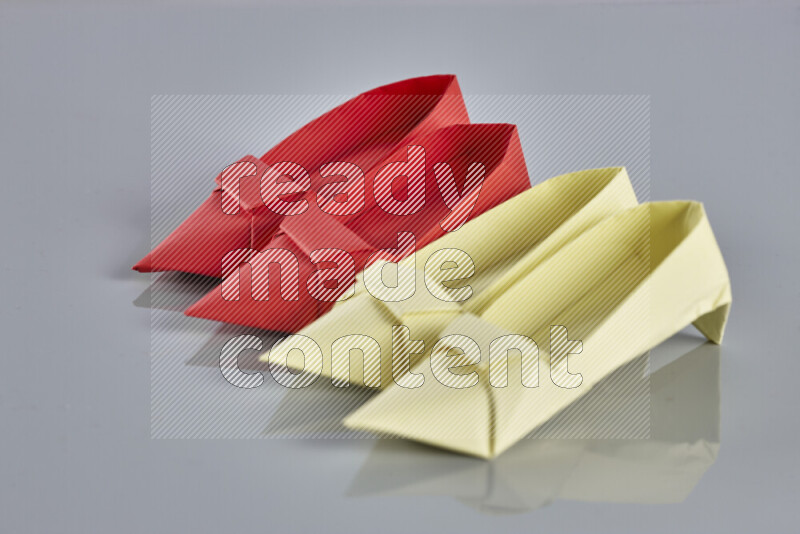 Origami shoes on grey background