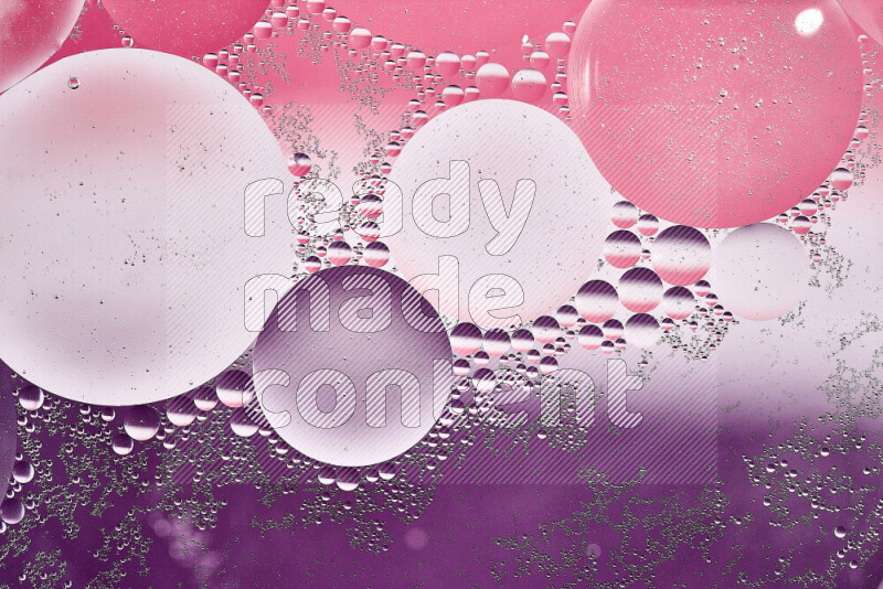 Close-ups of abstract oil bubbles on water surface in shades of white, purple and pink