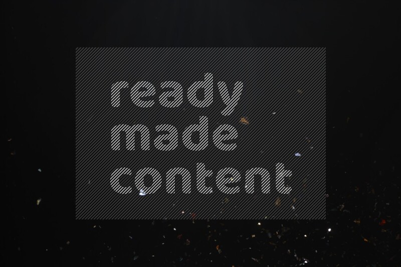 Falling multicolored confetti on black background