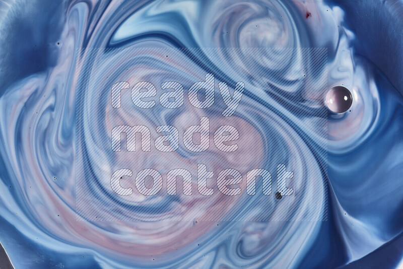 A close-up of abstract swirling patterns in blue, red and white