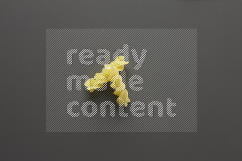Fusilli pasta on grey background
