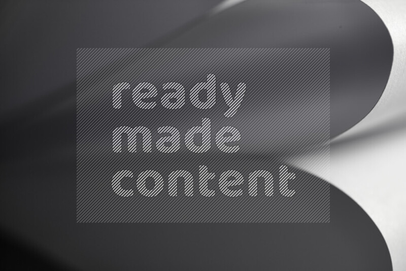 An abstract art showing grey paper sheets arranged in an overlapping curves