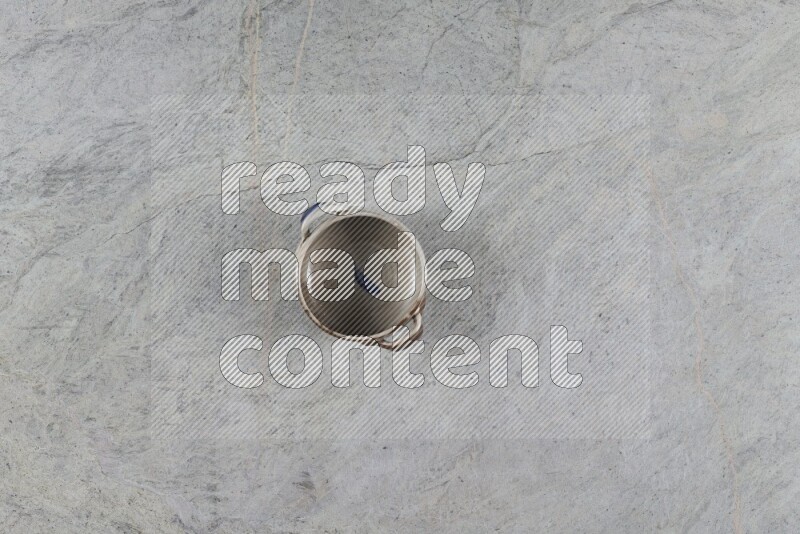 A multicolored pottery Bowl on grey marble background