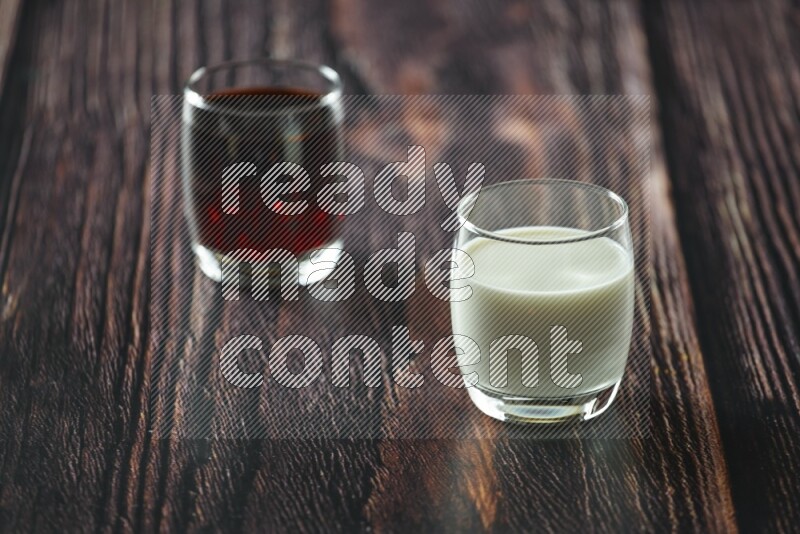 Cold drinks in a glass cup such as water, tamarind, qamar eldin, sobia, milk and hibiscus on wooden background