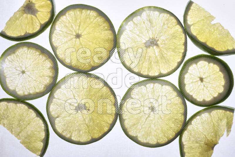 Orange slices on illuminated white background