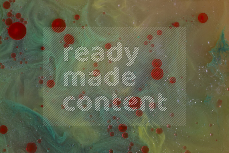 The image captures a dramatic splatter of red, green and yellow paints over the backdrop