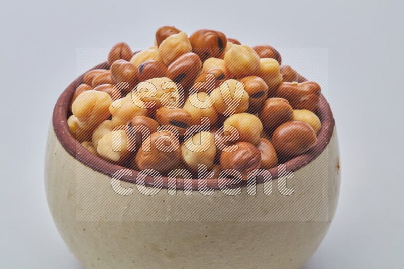 Close up shot of cooked fava beans (foul) & chickpeas on white background