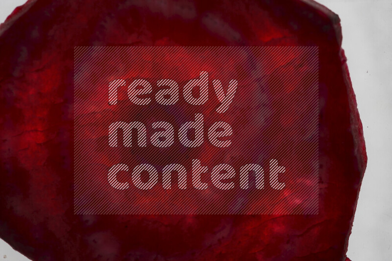 Beet slices on illuminated white background