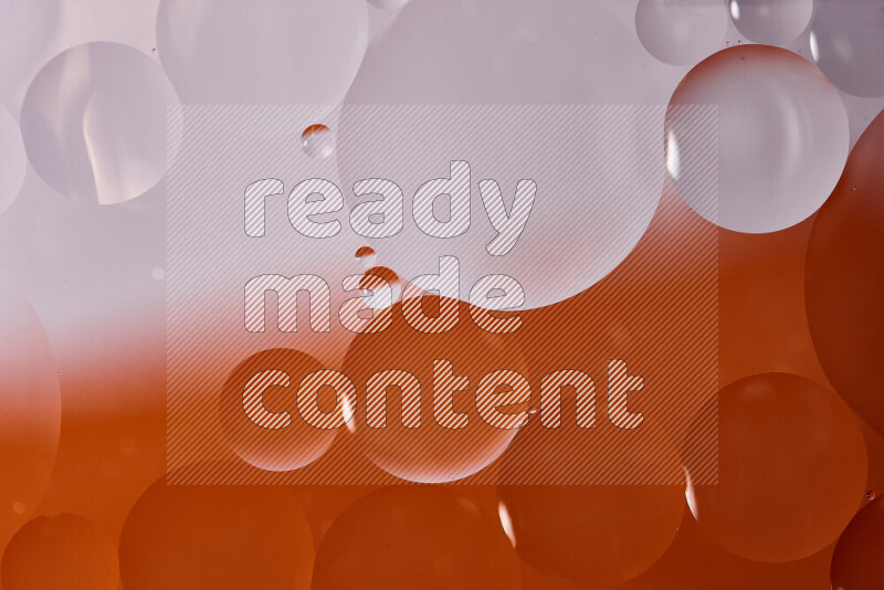 Close-ups of abstract oil bubbles on water surface in shades of white and orange